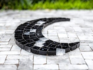 Black and White Crescent Moon Mosaic on a Stone Pavement