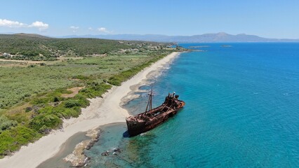 Abandoned shipwreck Dimitrios rests on a serene beach surrounded by clear blue waters in Gytheio...