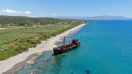 Abandoned shipwreck Dimitrios rests on a serene beach surrounded by clear blue waters in Gytheio...