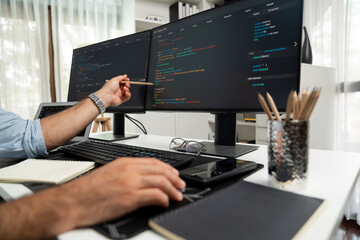 Cropped hands pointing of IT developer's data software development on pc, creating application...