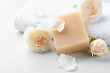 Aromatic soap bar and roses on light table
