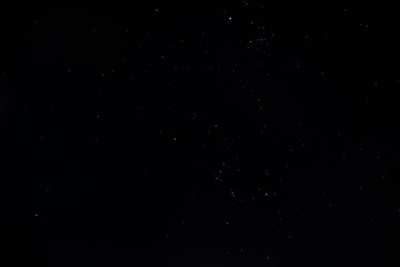 The dark night sky is strewn with bright glowing stars and various constellations	
