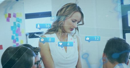 Marketing team tapping tablet screen and showing engagement with rising thumbs-up and heart icons - Powered by Adobe