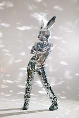 Mirror dancer performing in a bunny costume reflecting light