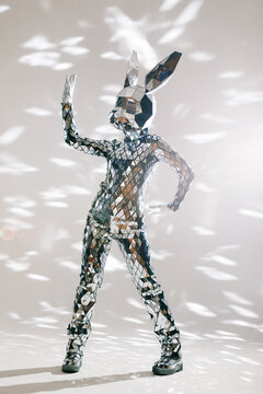 Fototapeta Mirror dancer performing in a rabbit costume reflecting stage lights