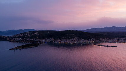 Sunset view over tranquil coastal town with mountains in the background in Gytheio of Lakonia in Greece
