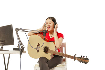 Beautiful Asian woman singing while recording in recording studio