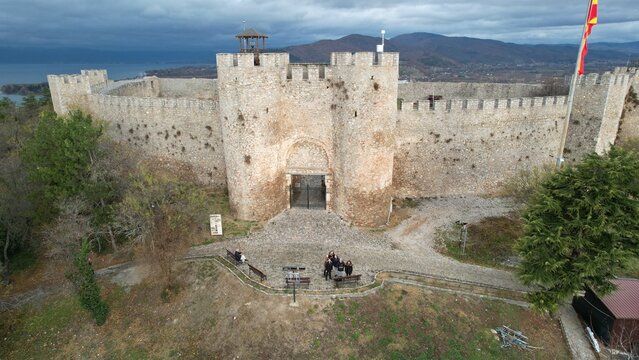 Historic Samuel's fortress overlooks serene coastal town with modern architecture under cloudy sky, Ohrid
