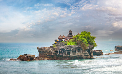 Braving the ocean waves on a rock formation, the Tanah Lot Sea Temple on the southwest coast of...