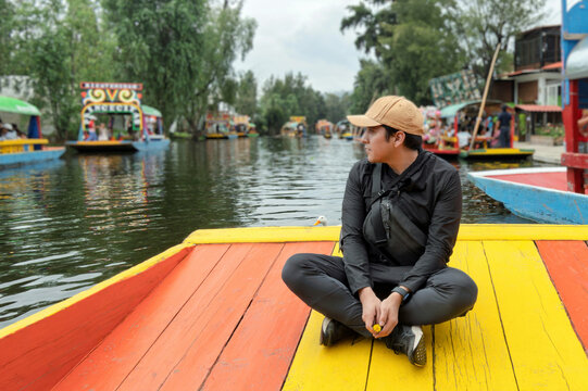 Enjoying a tranquil moment on a trajinera in Xochimilco, Mexico with vibrant colors