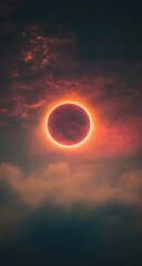 Obraz premium Fiery eclipse, red sun ringed by clouds