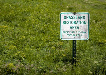 grassland restoration area sign on meadow in public park in new york state (please let it grow) nature ecology restore plants flora service