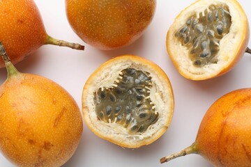 Ripe passion fruits on white background, flat lay