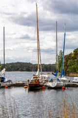 Boats and yachts at the pier on the lake on a spring day