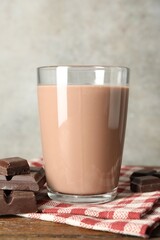 Chocolate milk in glass and ingredient on wooden table
