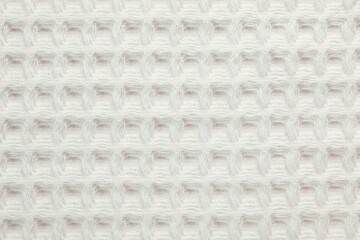 Clean white waffle towel as background, top view