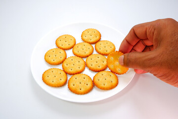 biscuits layering together over white plate with white background close-up view 