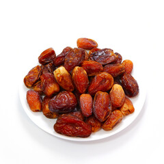 A full plate of dates fruits closeup shot  on white background 