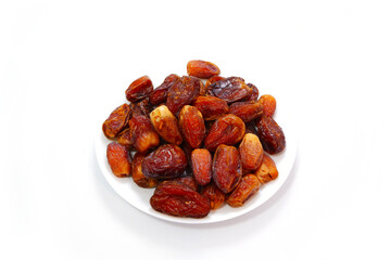 A full plate of dates fruits closeup shot  on white background 