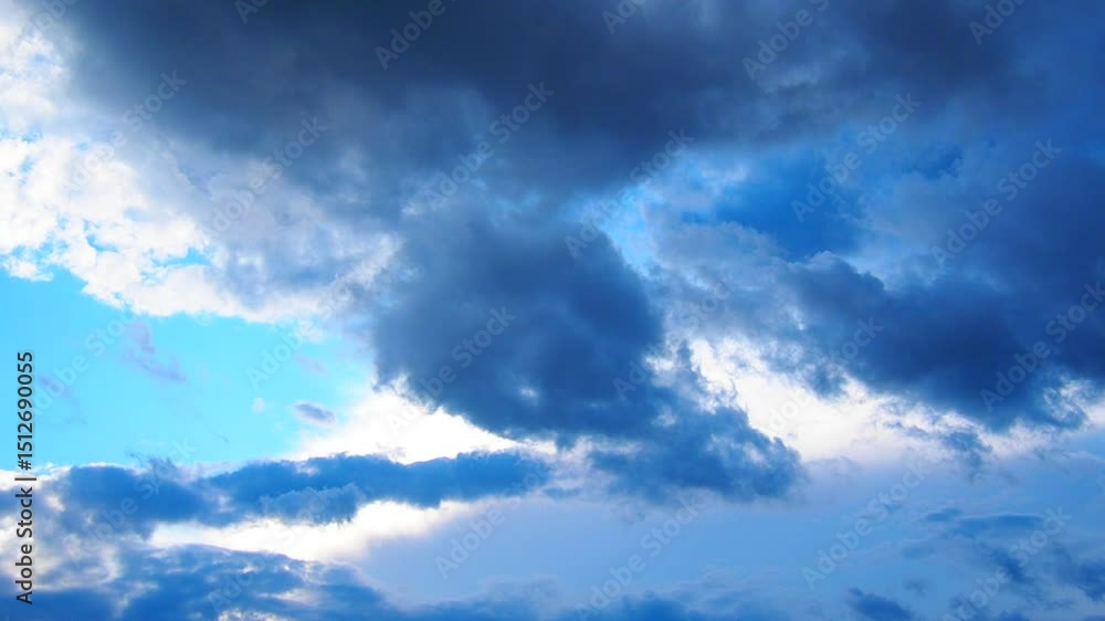Poster Clouds dance and shift gracefully against a vibrant blue canvas, inviting reflection and calm. Soothing hues blend as the sun peeks through, creating a serene atmosphere of tranquility
