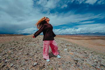 Young woman enjoy freedom in the mountains on summer day