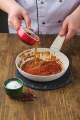 Step by step cooking of gochujang pepper paste at home on dark wooden background. Korean cuisine.