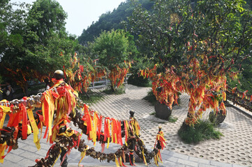 Red ribbons or cloth talismans tied to pillars in Taoist temples at Yuntaishan Geopark is the most beautiful geopark in Henan Province, China.It is listed as the first World Geopark in the world.