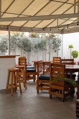 Charming outdoor dining area featuring sturdy wooden chairs, ideal for relaxing meals in a natural and inviting atmosphere with timeless style.

