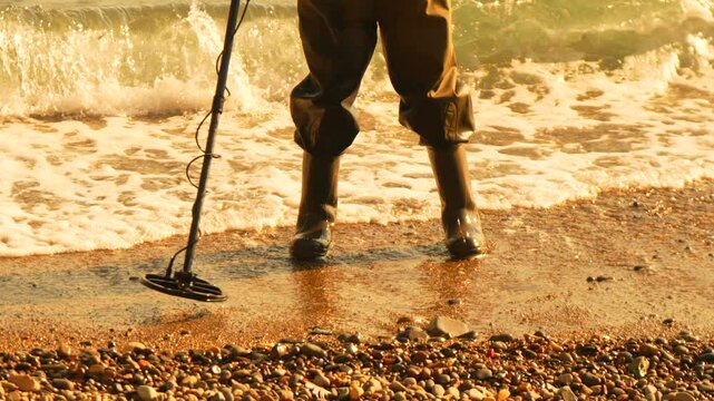 Treasure Metal Detecting beach Treasure hunter searches seaside for valuables. Sunny day.