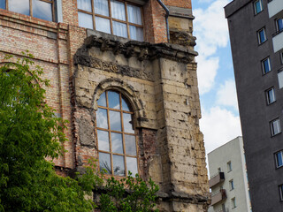 Historic brick industrial building facade with arched windows showcasing heritage architecture in...