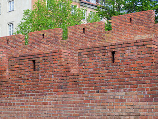 Ancient red brick medieval wall texture with weathered surface showing historical construction craftsmanship
