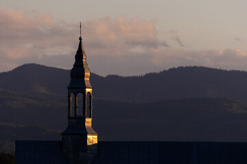 A beautifully lit silver church steeple at twilight, glowing under the last light of day. Majestic...