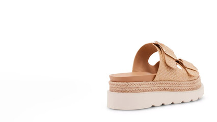 Stylish beige sandals with woven texture and chunky sole displayed against a simple background