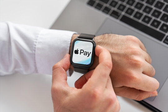 Businessman using apple pay on smart watch for contactless payment