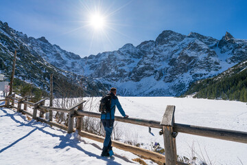 Tourist in front of the frozen Sea Eye lake in Tatra mountains. Poland  © Pawel Pajor