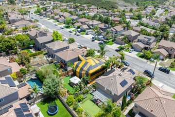 Aerial view of yellow and gray termite tent on a big house in San Diego, South California