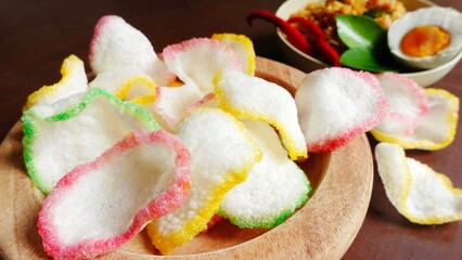 Onion crackers on a wooden plate. Typical Indonesian side dish. Typical Indonesian savory crackers.