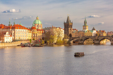 Fototapeta premium View of Charles Bridge and sightseeing boat on Vltava River in Prague, Czech Republic