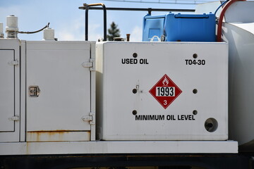 Used oil tank mounted on back of service vehicle.