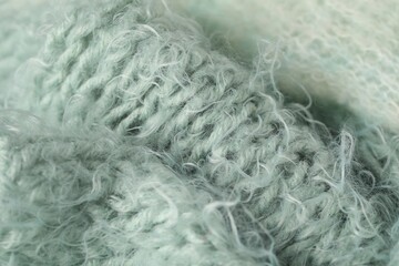 Texture of turquoise wool fabric as background, closeup