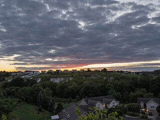 Breathtakingly colorful sunset over suburban houses on a summer evening in Pennsylvania, USA.