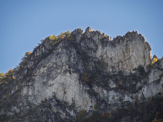 Close-up view of the jagged summit of Seneca Rocks with blue sky in the evening