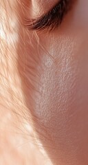 Fototapeta premium Close-up of a pale face, light catching cheek, and eye