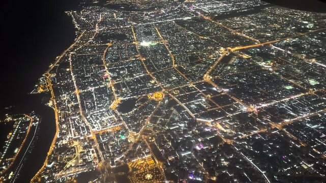 View from a plane flying over Dubai at night. 