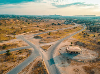 Arid landscape with crossroads and building, filmed from above showing natural beauty
