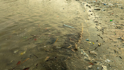 Plastic waste, plastic cups at the beach. Concept of environmental problems and saving the plane	