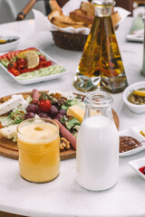 Milk Bottle and Glass of Orange Juice on Breakfast Table-Natural Dairy and Fruit Juice for Morning Meal