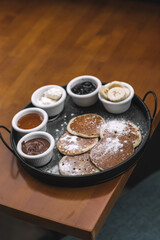 Pancake Breakfast Tray with Chocolate, Banana, Honey, Jam, and Cream-Pancake Brunch with Mixed Sweet Sauces and Fruit Garnish