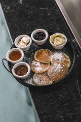Pancake Breakfast Tray with Chocolate, Banana, Honey, Jam, and Cream-Pancake Brunch with Mixed Sweet Sauces and Fruit Garnish