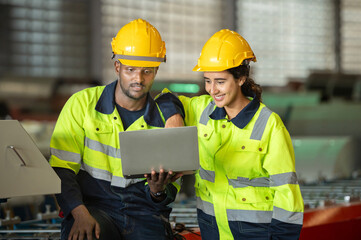 technician Factory mentor teaching apprenticeship trainee operating machine looking monitors and check Production process machinery. Two engineer technician foreman worker explaining control machine